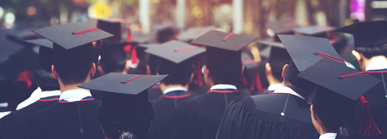 Students at graduation dressed in black caps and gowns