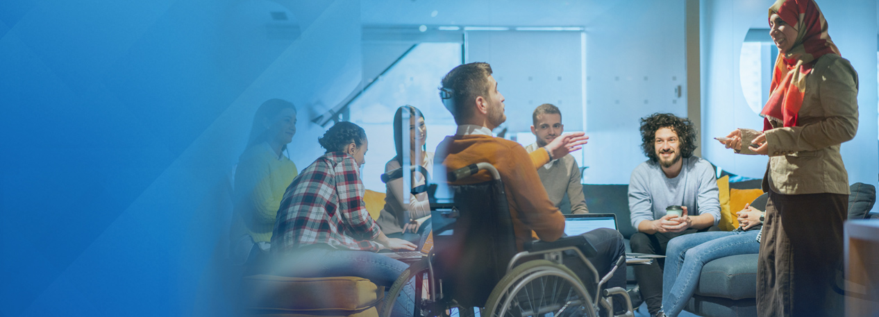 A group of diverse individuals engage in conversation.