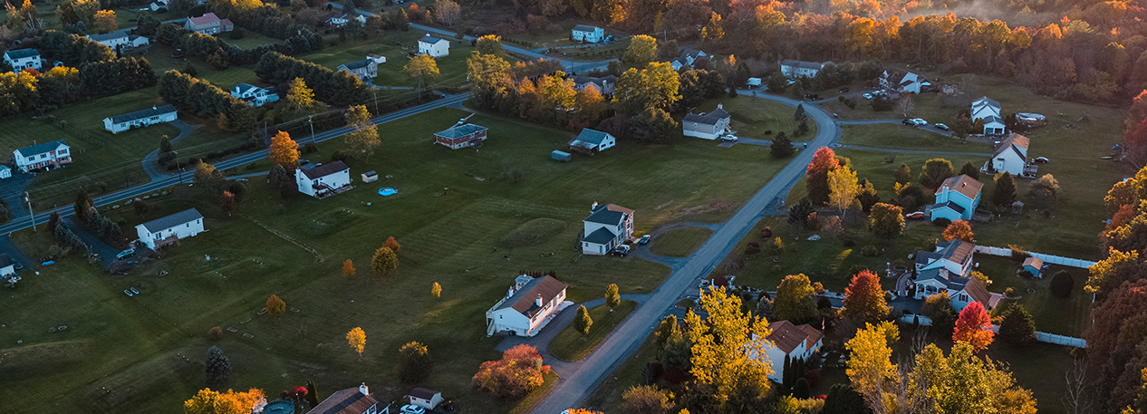 The sun rises over a rural town.