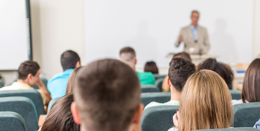 Audience in auditorium classroom watching a presenter
