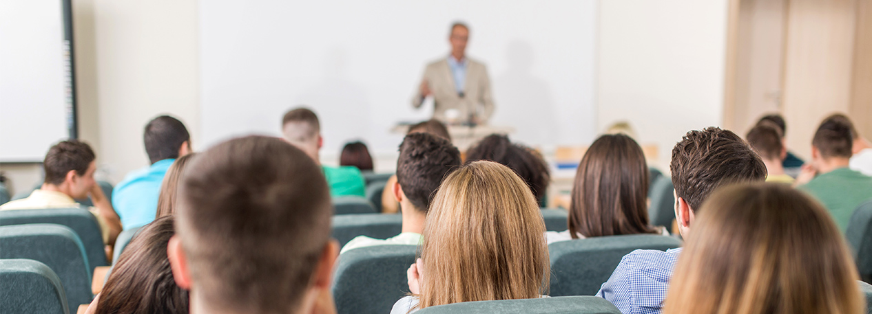 Audience in auditorium classroom watching a presenter