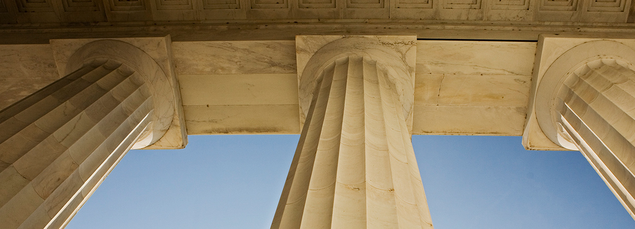 Looking up at the capitals of a row of fluted columns