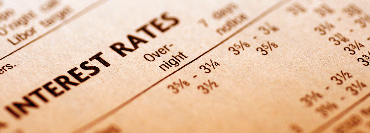 Paper with various numbers and the words "Interest Rates" visible