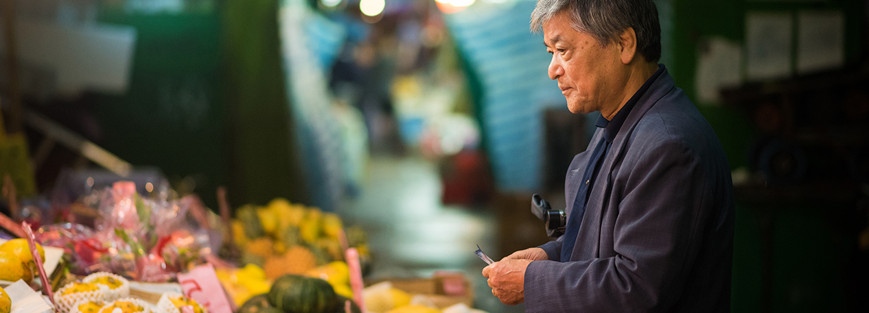 Man looking at fruit in a market