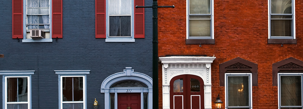 Doorways and windows of two brick townhouses