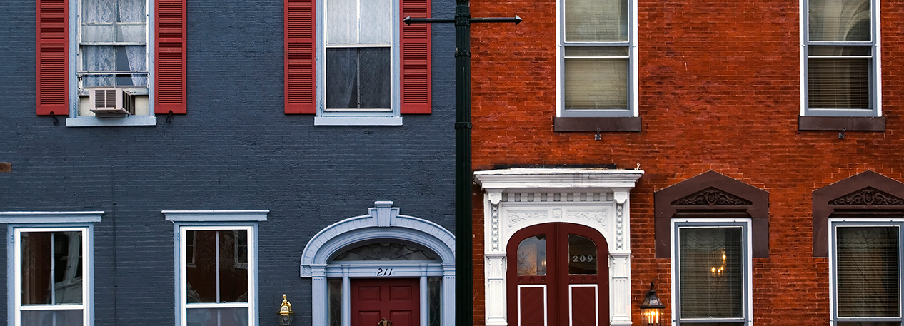 Doorways and windows of two brick townhouses