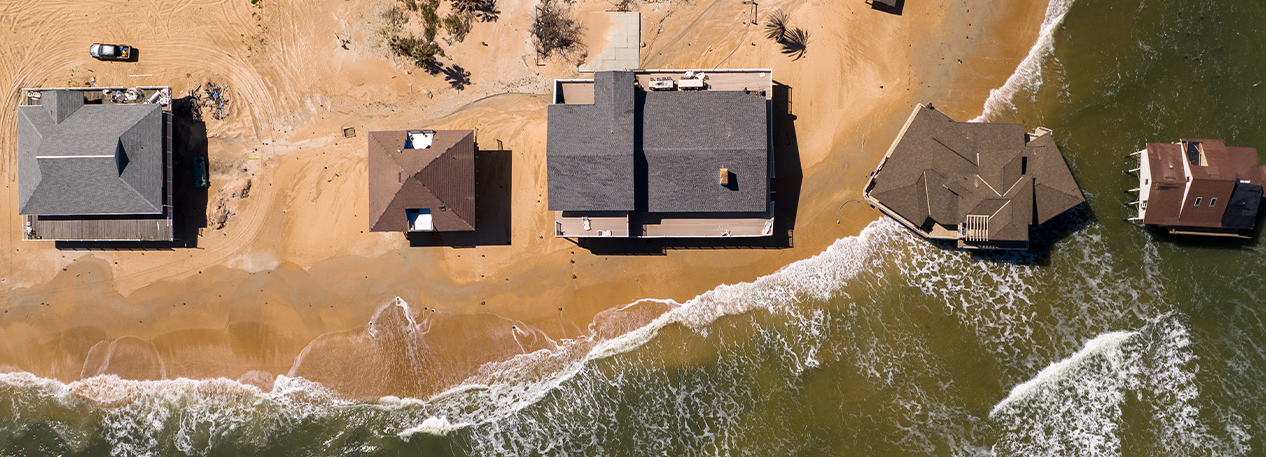 A drone captures a bird's eye view of the ocean overtaking coastal homes.