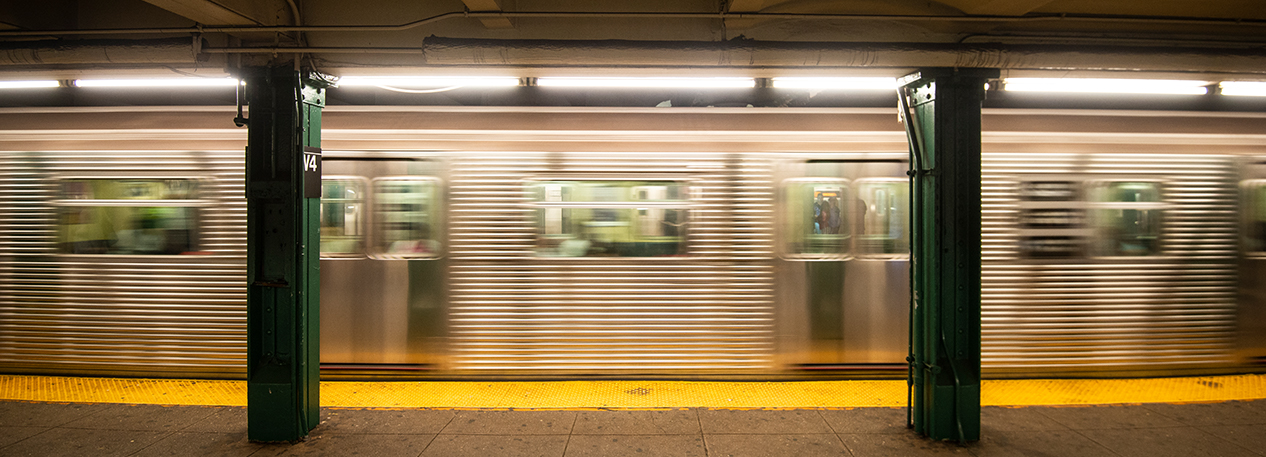 A subway car approaching a quiet platform. The long exposure captures the train motion. The aluminum designed cars swoosh past the platform creating a great effect.