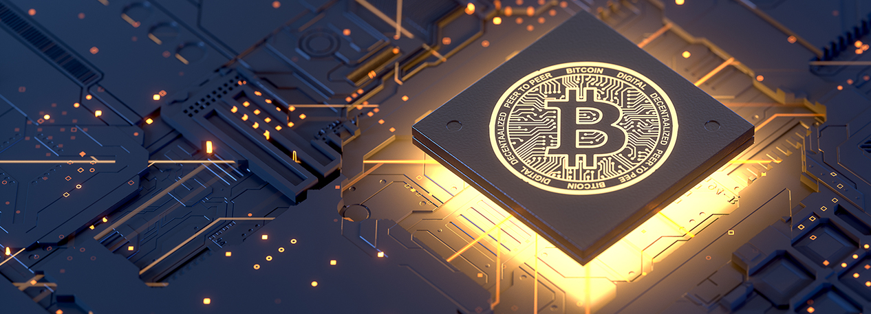 A bitcoin symbol sitting on a computer chip is illuminated from below.