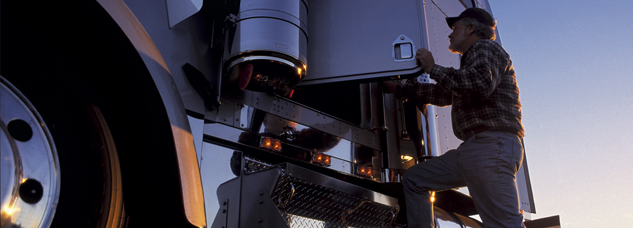 Close-up of truck driver getting in his cab