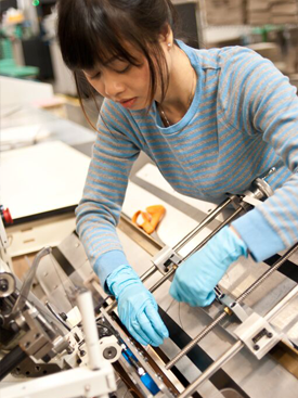 A worker uses equipment at RPI, a print manufacturer and fulfillment partner that received an investment from HCAP Partners.