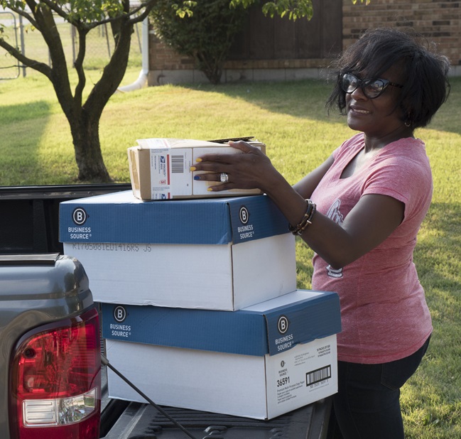 Nina Fields, of Cahokia, IL, prepares packages for shipping after she received a $14,000 microloan from a subsidiary of Justine PETERSEN, a CDFI that received financing as part of a partnership between the Opportunity Finance Network and Woodforest National Bank.