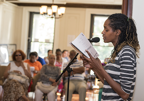 A local writer reads her work at an event for writers at Drexel University's Dornsife Center for Neighborhood Partnerships.